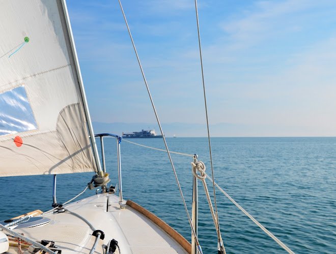 Sailing on Lake Constance on a calm sunny day with passenger boat in background