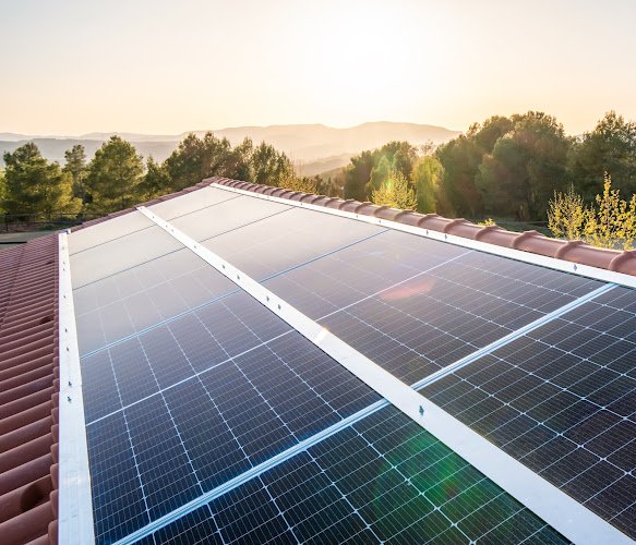 Side view of new solar panels on the roof of a house on a sunny day.