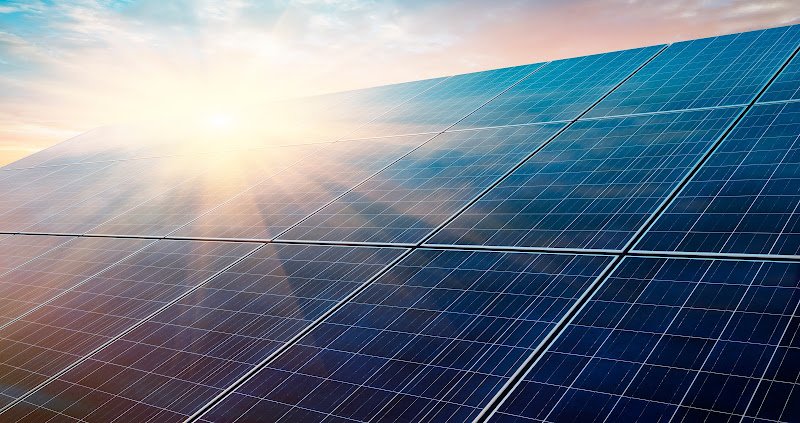 Photovoltaic system in front of a bright sunrise morning sky