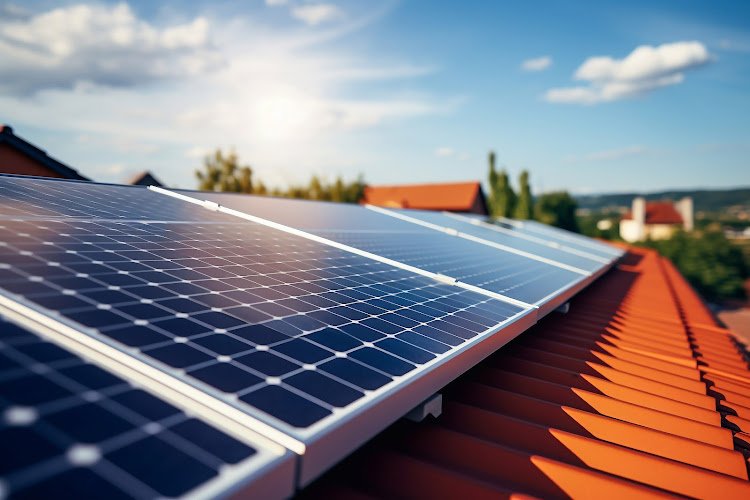 Solar panels on the roof of the house and blue sky. Generative AI.